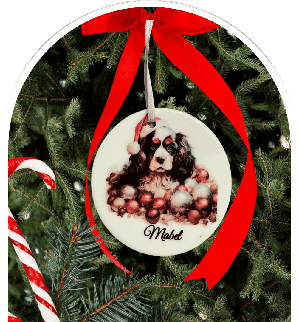 Dog ornament on Christmas tree with ribbon.