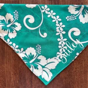 Green floral bandana with white designs.