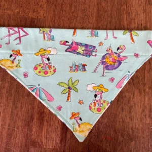 Colorful flamingo-themed bandana on wooden surface.