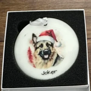 Christmas ornament featuring a German Shepherd wearing a Santa hat.